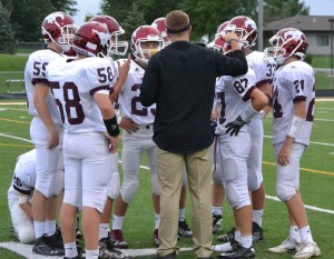 The JV team huddles during the game against Solon Aug. 26. Photo by Jan Moore.