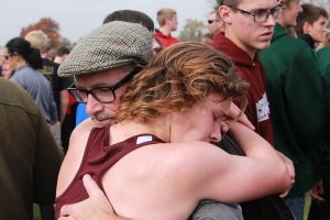 Liam Conroy hugs his dad after the race. "He's my inspiration, he taught me my work ethic. He's the one who told me I should go out for cross country, and I wouldn't be where I am without him," Conroy said about his father. Photo by Ben McGuire.