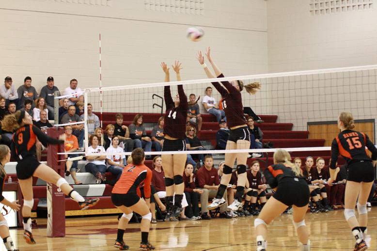 Alli Schutt (14) and Emma Pisarik (16) go up for a block in game 2 against West Delaware.  They lost the game 25-23.