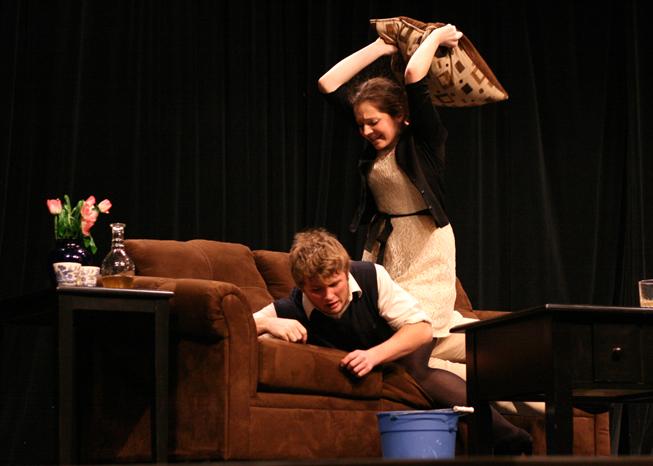 Veroniqe (Kaitlin Thune, senior) beats Michel (Connett Croghan, senior) silly with a pillow during an excalating argument during the performance of the one act production, God of Carnage.  The performance took place during the open rehersal at the district auditorium on Feb. 3.  The group got perfect scores at the state speech competition on Feb. 4. (Photo and Caption by Cassidy Steines)