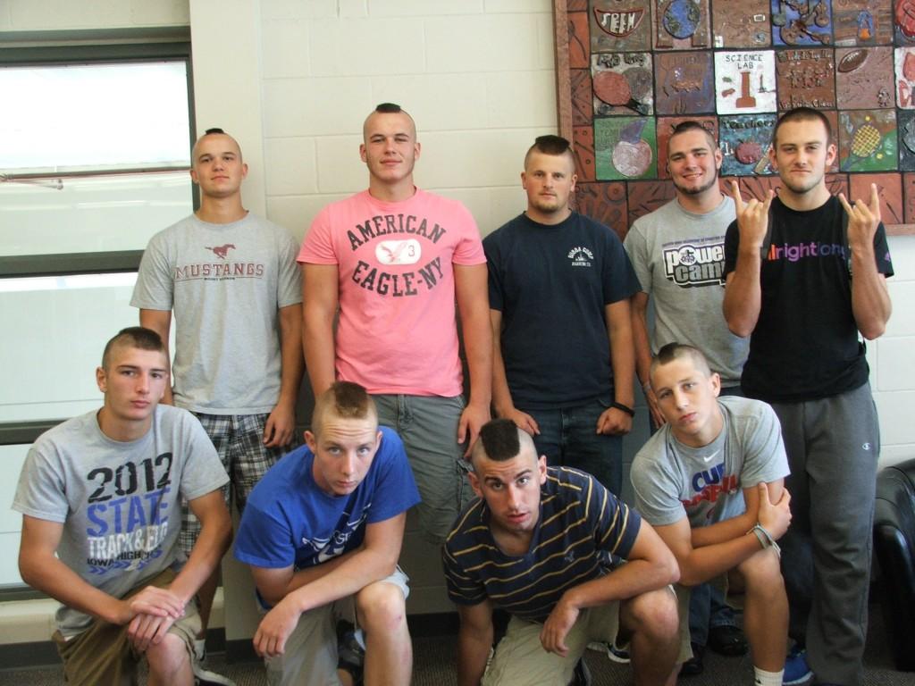 Mount Vernon football players show off their mohawks in the high school library on Thursday. Front Row: Noah Dahlstrom, Logan Walker, Jake Muller, and Trey Ryan.  Back Row: Jacob Lueth, Carson Kuntz, Keanan Shannon, Josh Cannon, and their barber, Chase Younggreen.