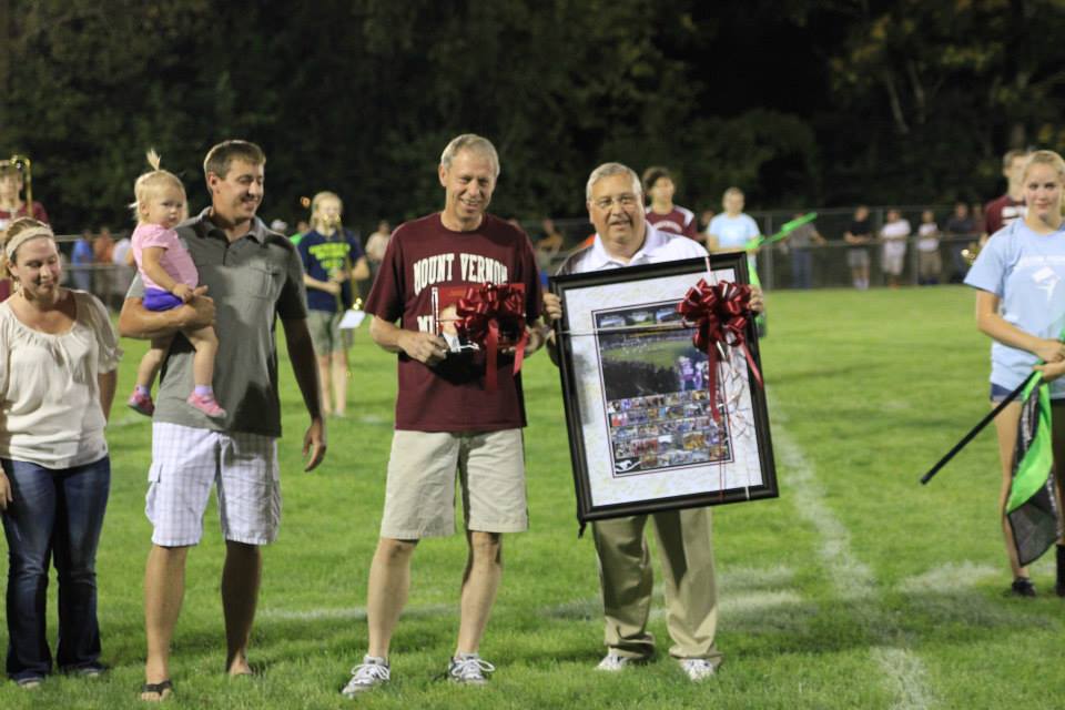 Superintendent Gary OMalley presents Tom Wieseler with at photo composite of Mr. Wieselers many services to the schools.  The frame was signed by staff and faculty of the school district.