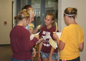 Sophomore Anne Liberko guides freshmen around the school during orientation Aug. 13.