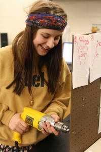 Sophomore Jenny Deininger works on the Rube-Golberg machine for Mission Possible March 10. Photo by Renny Klein.