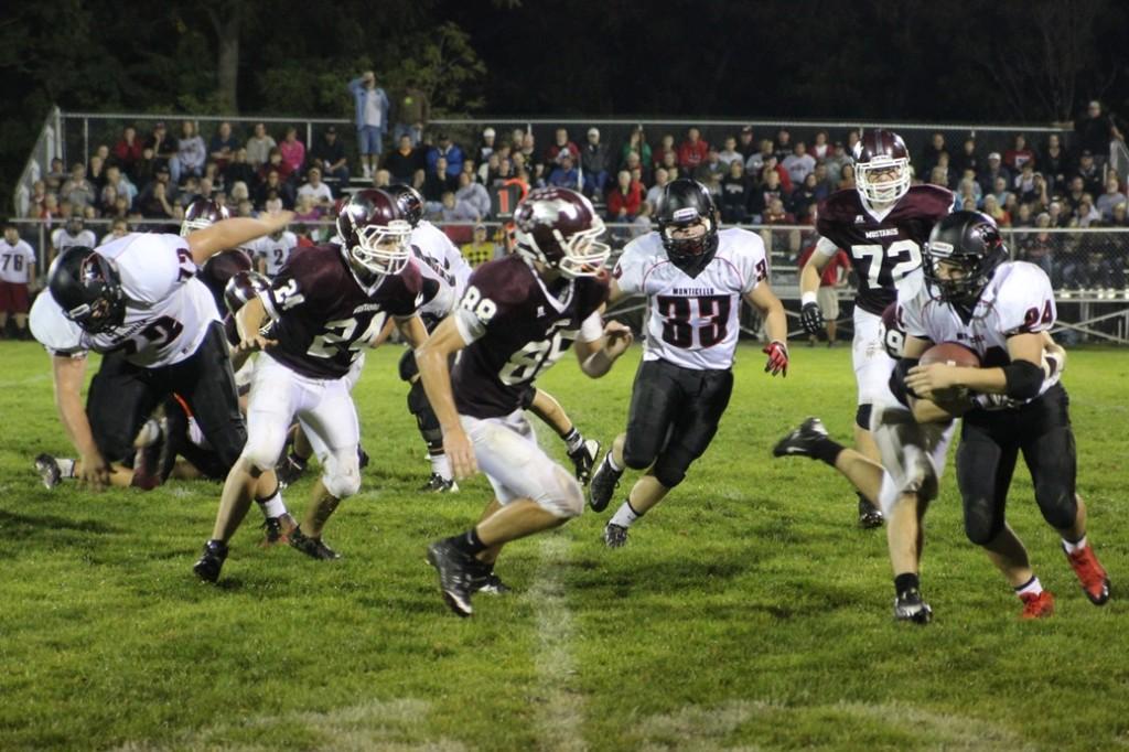The Mustangs kept up their fight. Here's a tackle by Ryan Ackerman (39). Photo/ Claire Pettinger