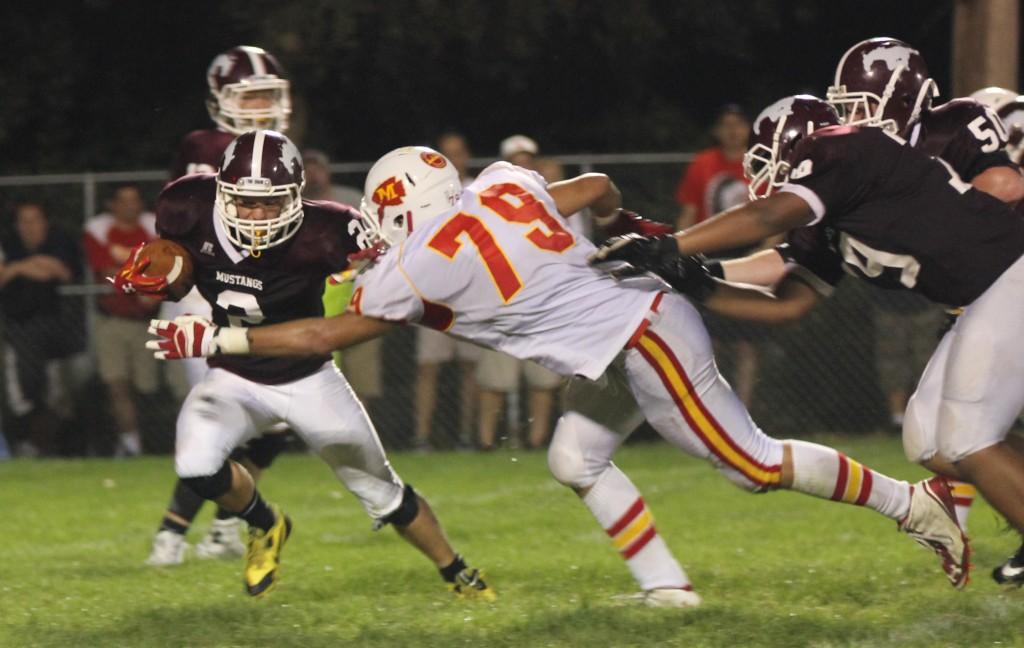 Mickey Hines (2) runs the ball against Marion. Photo by Trevor Baty.