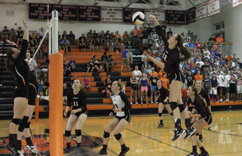 Senior Emma Cochrane spikes to ball against Solon Sept. 4. Photo by Claire Pettinger.