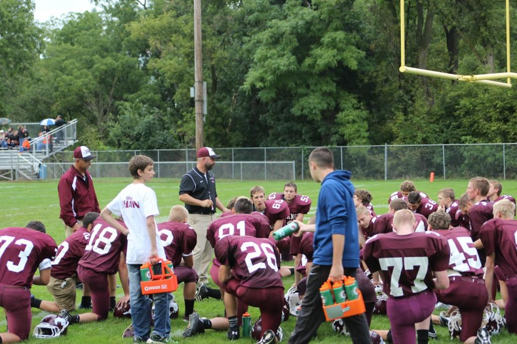 The Junior Varsity team gathers for a word from the coach before playing Solon Sept. 5.