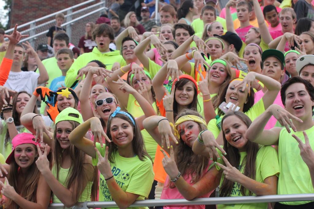 The crowd makes an MV symbol to cheer on the team Aug. 29. Photo by Lexi Kelly.