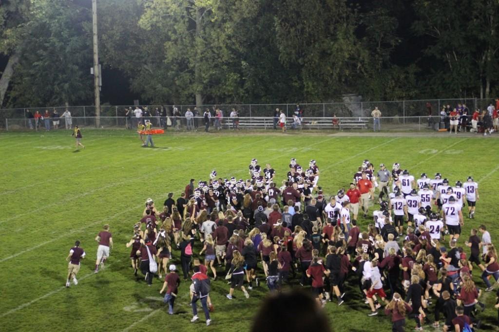 The fans storm the field to support their winning team. Photo/ Maggie Rechkemmer.
