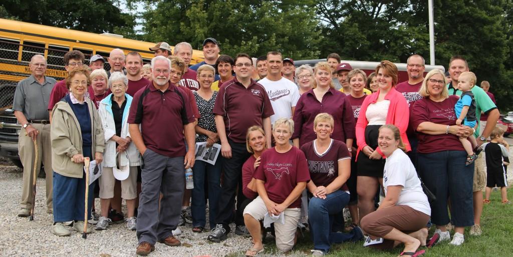 Workers and donors who helped with the Save Our Field project pose for a photo in the endzone. Photo by Lexi Kelly.