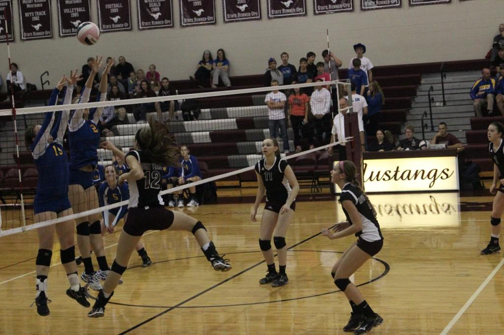 ​Emma Cochrane (12), attacks the ball in an attempt to save this intense play.  Photo by Claire Pettinger.