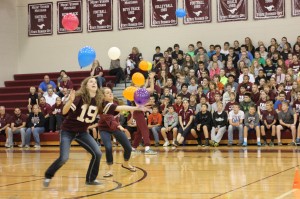 Volleyball players Morgan Melchert and Emma Cochrane attempt to keep balloons in the air at the All School Assembly Sept. 26. Photo by Gabby Zahradnik.