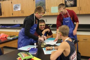 In biology class on Aug. 19, a group of sophomore boys laugh while conducting an experiment to study and practice the scientific method.