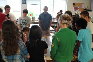 Students in Beginning Drawing and Painting circle up to critique a fellow classmate's work on Aug 29. The artists were perfecting their 3D drawing skills for the past week. 