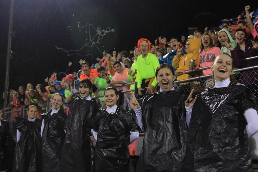Fans dressed for neon night, but switched to garbage bags when the rain didn't quit. Photo by Abdur Rafay.