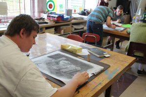 During a Beginning Drawing class on Aug. 27, sophomore Cameron Ling uses shading techniques and charcoals to create a drawing of wooden blocks. 