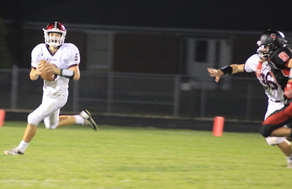 Quarterback Drew Adams looks for a receiver in the game against Monticello Sept. 25. Photo by Sam White.