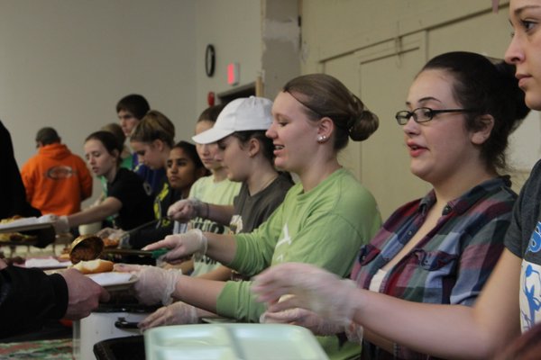The Social Justice class taught by Leigh Ann Erickson and Shawn Voigt serves food at Mission of Hope in Iowa City Jan 5. Photo/Grace McCollum.