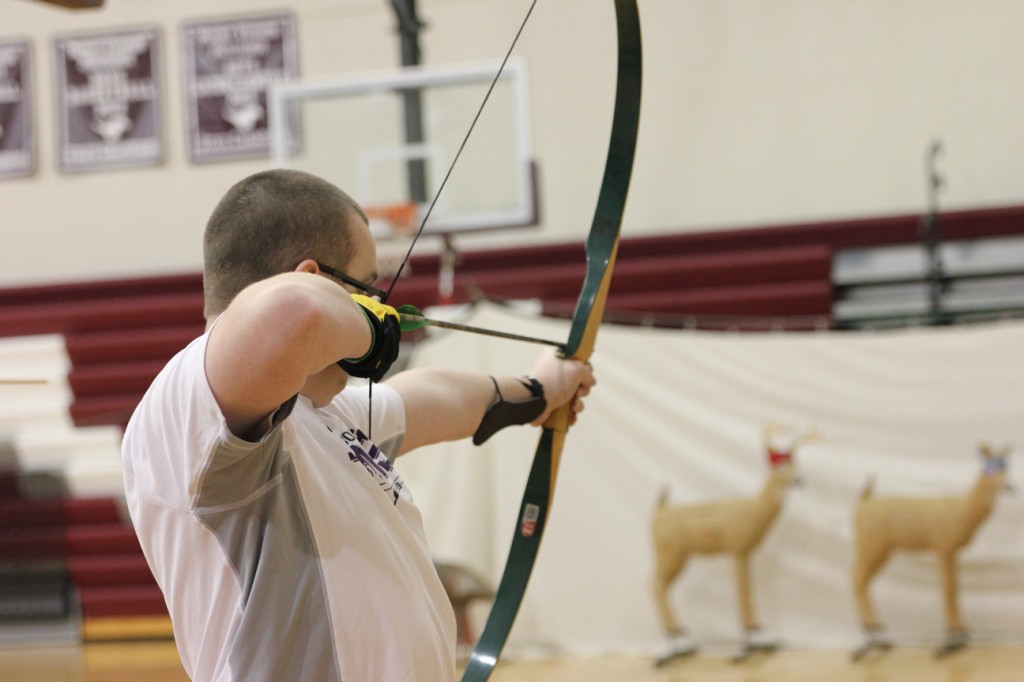 Junior Alex Moore takes a shot at a 3D deer Jan. 12 in Outdoor Pursuits, taught by German teacher and archery coach Tom Wilkinson. Photo/Zach Niehaus.