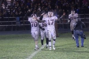 Seniors Joe Corcoran and Chris Chapman celebrate after their regional final upset against Anamosa on Nov. 6.