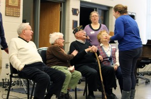 John and Betty Wolfe and Fred and Marion Lehman  speak to U.S. History students at Mount Vernon High School about their experiences during World War II. Foreign exchange student Lara Celeghin from Italy shows Mr. Lehman a picture she drew of him during the presentation. Photo by Abby Davidson.