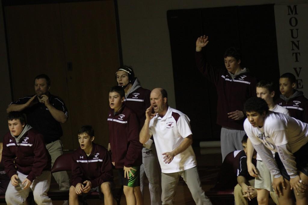 Coach Vance Light cheers on a wrestler Feb. 8 in the Regional Final against Assumption. Photo/Kelsey Shady.