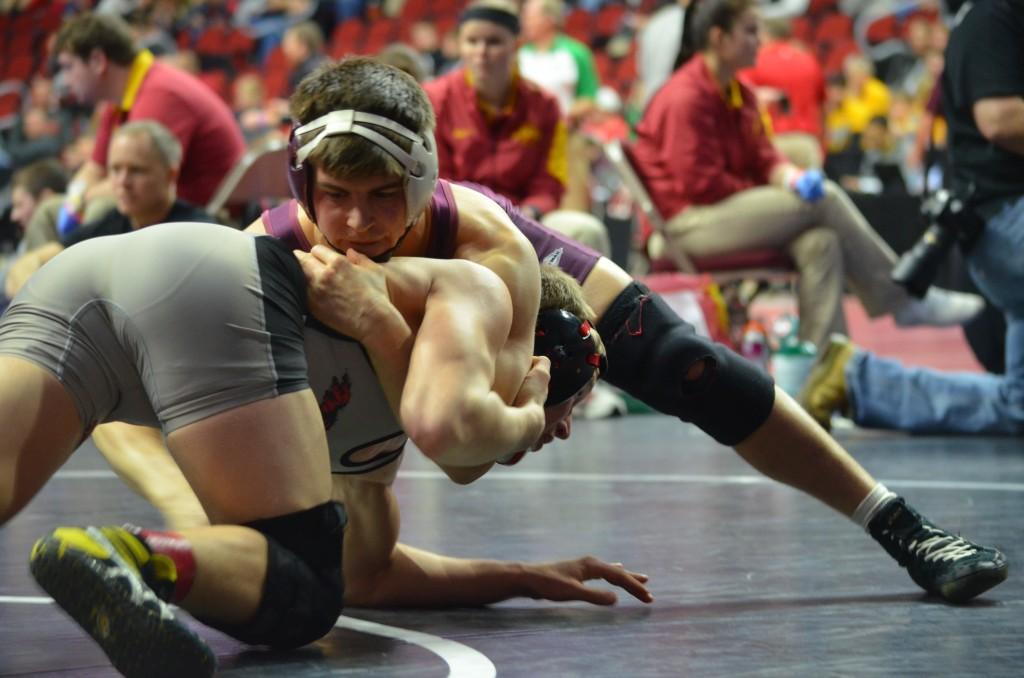 Senior John Engelbrecht  fights to win his second consellation round against Harlan's Jacob Wingert.  Photo: Kelsey Shady  