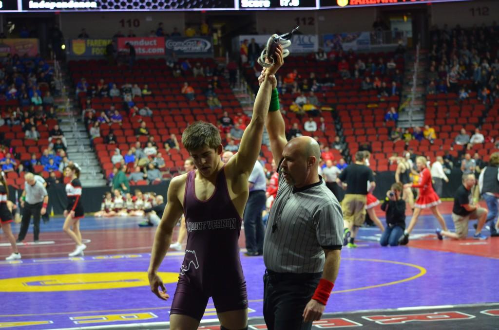 Senior John Engelbrecht gets his hand raised after defeating  Harlans J. Wingert to win his second cancellation round.  Photo: Kelsey Shady 