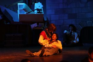 In battle, Eponine dresses up as a student and fights. She is shot and dies in Marius' arms.