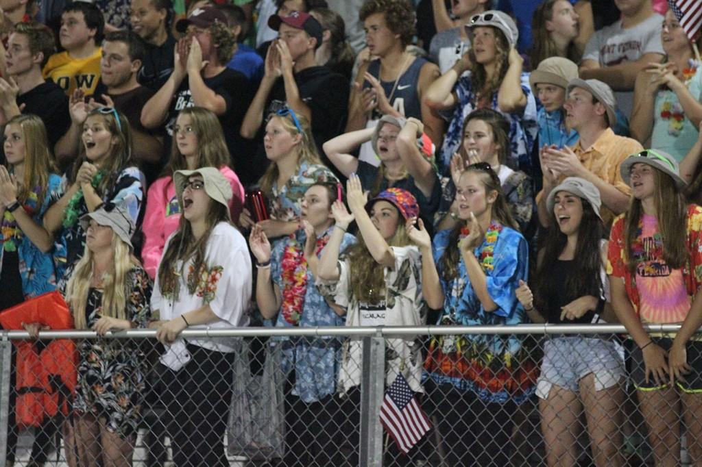 Dressed in Hawaiian attire, the Mount Vernon student section reacts to Solon's interception in the fourth quarter. Photo by Paige Zaruba.