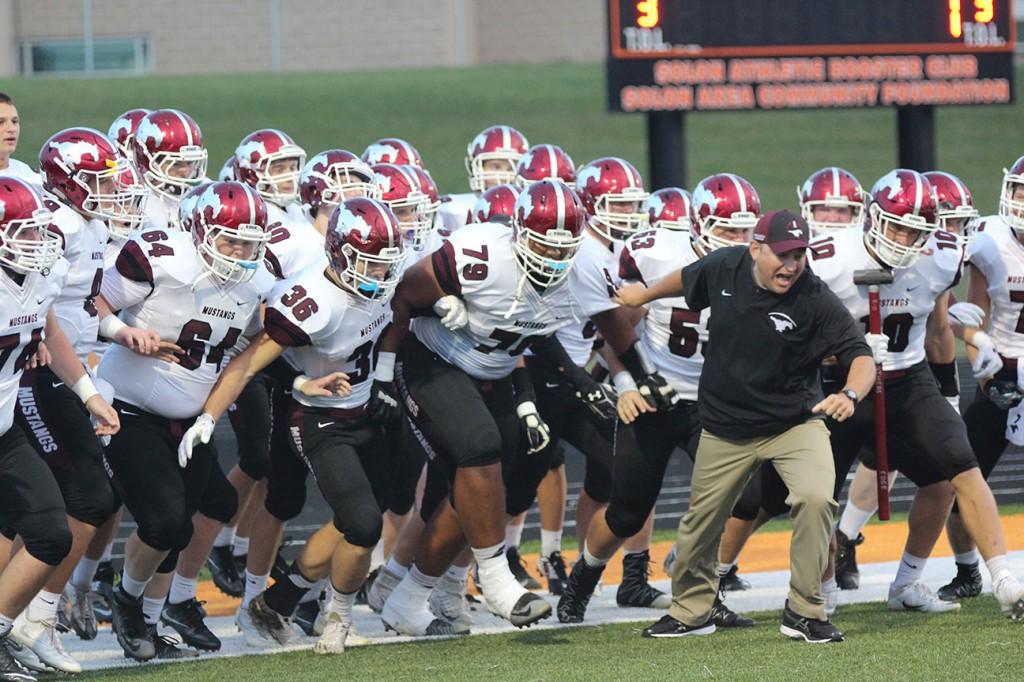 Coach Haddy leads the rush onto Solons field Aug. 26. Photo by Emma Klinkhammer.