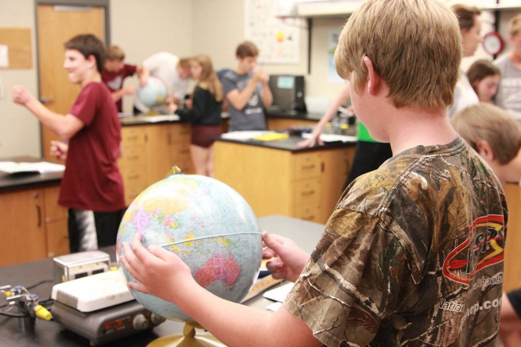 Freshman Logan Kelly performs an experiment in Earth Science class during the first block period of the year. Photo By Ben McGuire.