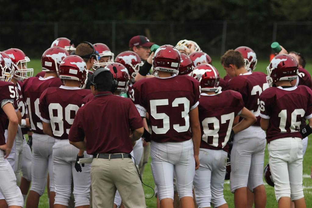 Freshmen football huddles during timeout at the end of their game. (photo by Emma Klinkhammer)
