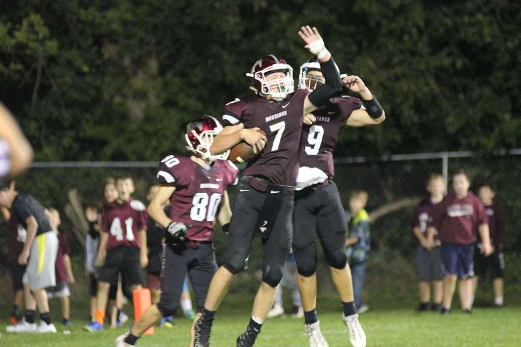 Jumping in the air, Cale Snedden celebrates his touchdown with teammate, Drew Adams