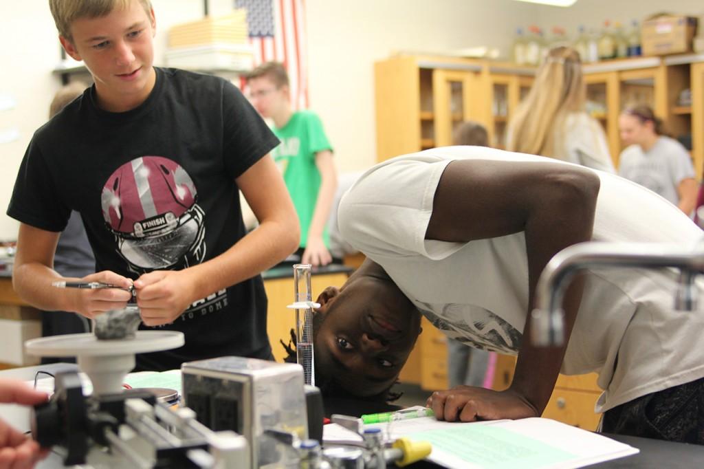In Earth Science, sophomore Jamal Johnson examines a graduated cylinder with freshman Garrett Hormann. On the first day of block scheduling, Mrs. Appley's students tested out lab equipment. Photo by Paige Zaruba