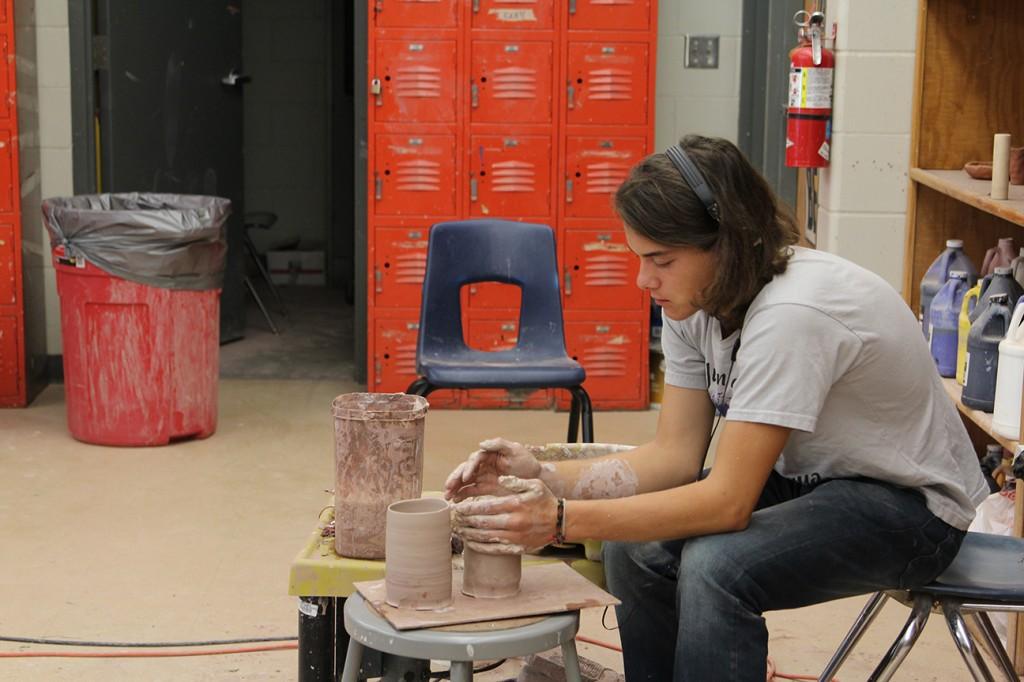 In Ceramics, Junior Aleck Krob spends his first block day making a cylinder pot. Photo By: Summer Everhart