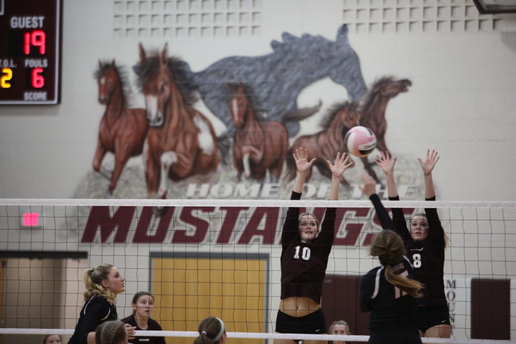 Katie Wycoff and Catherine Yeoman block the ball during their playoff game against Williamsburg on Oct 25.