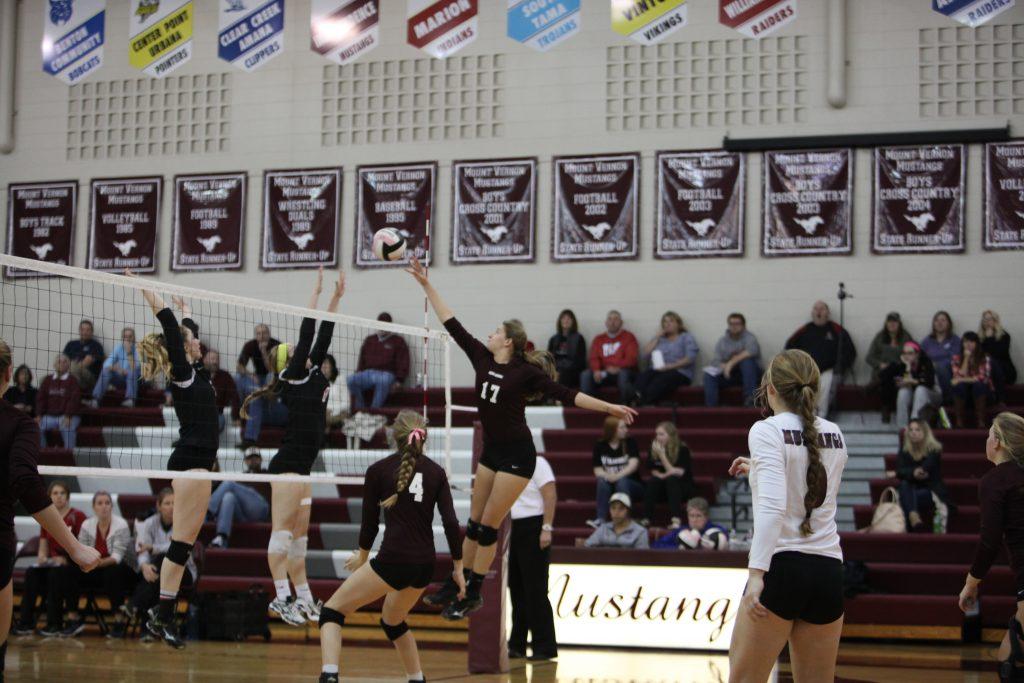 Kaitlyn Volesky reaches to tip the ball over the net against Williamsburg.