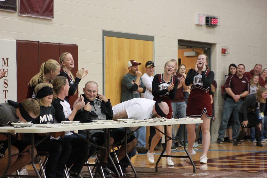 Maggie Willems, Sue Deibner, and Matt Haddy laugh alongside Preston Petersen and Matt Browning who think they're involved in a pie eating contest. Photo by: Summer Everhart 