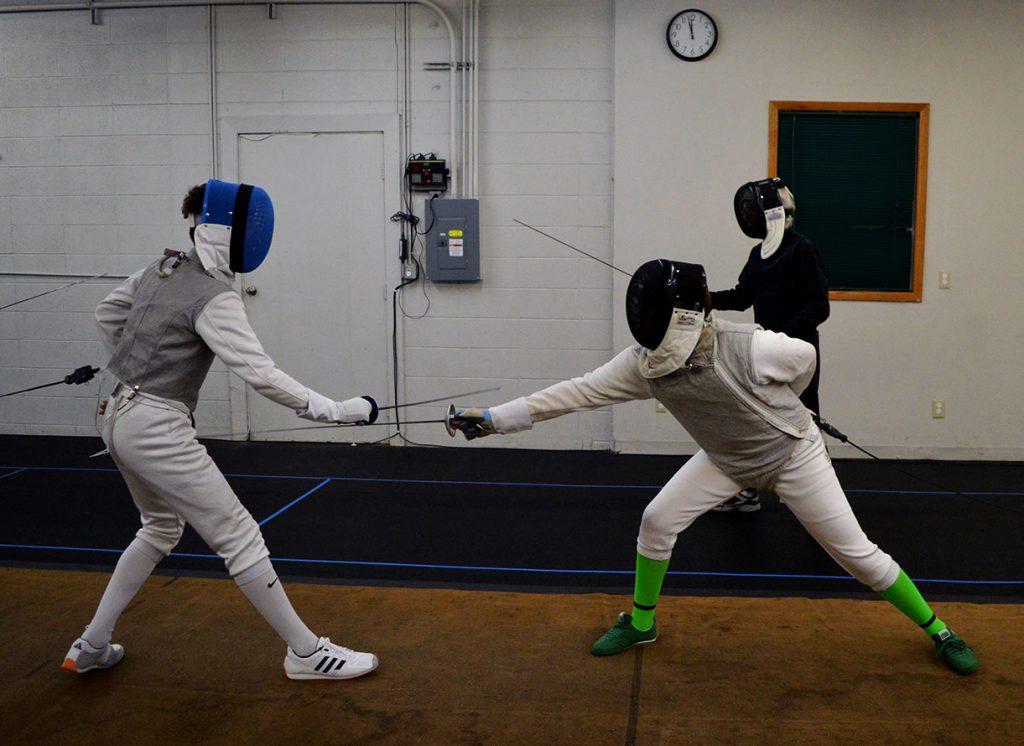 Adrian Dale (right) spars with a friend at the Iowa City Fencing Center on Oct. 11.