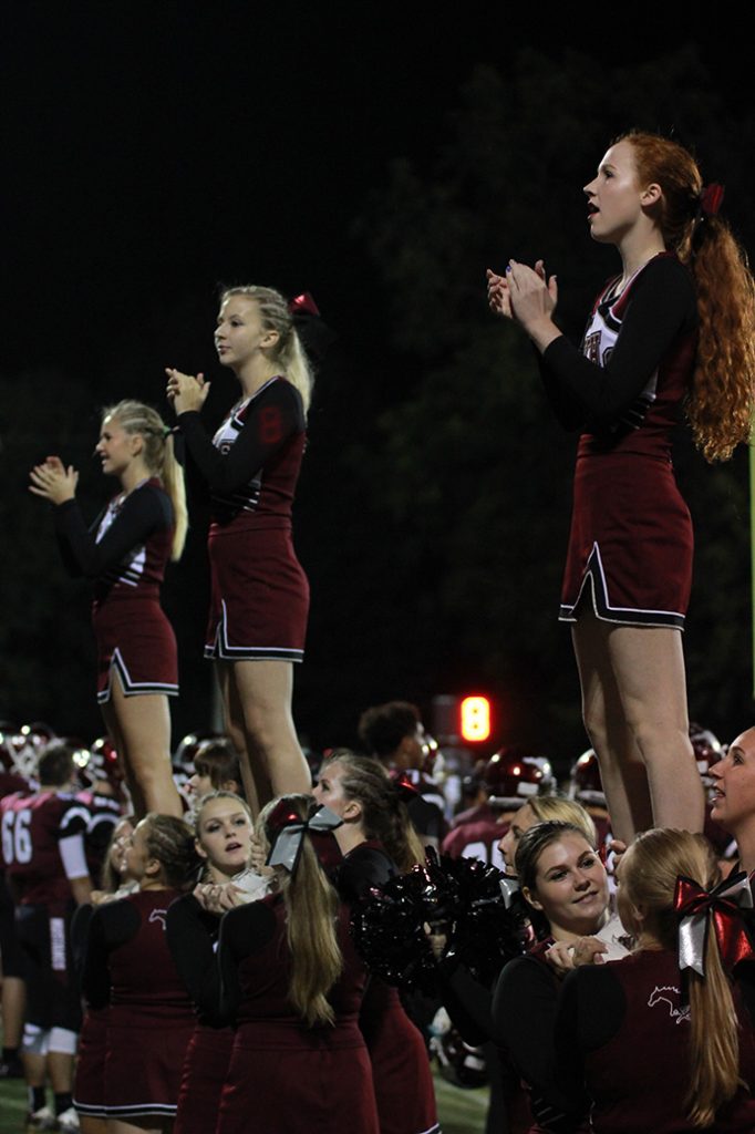 Cheerleaders chant at the game Sept 30. Photo by Emma Klinkhammer.