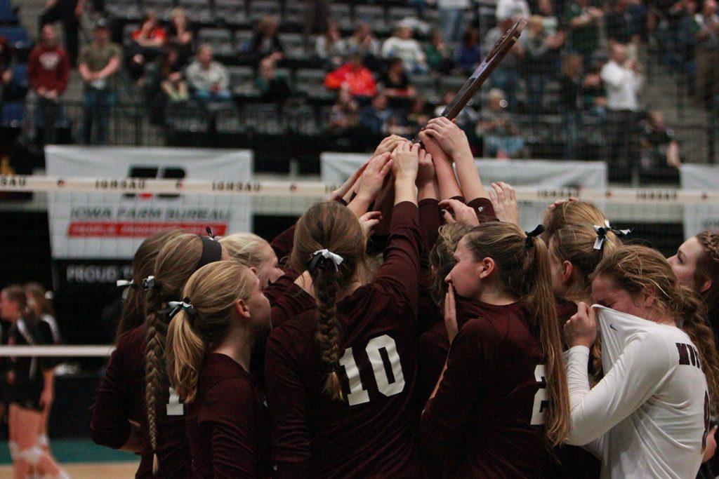 The team gathers around their trophy after losing to Union in  four sets.