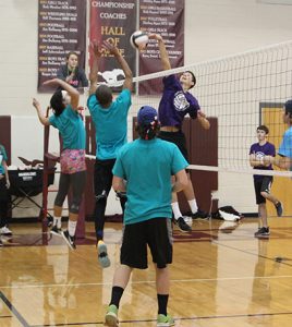 Austin Ash, a senior, spikes the ball during a match against the sophomores. Photo by Paige Zaruba. 