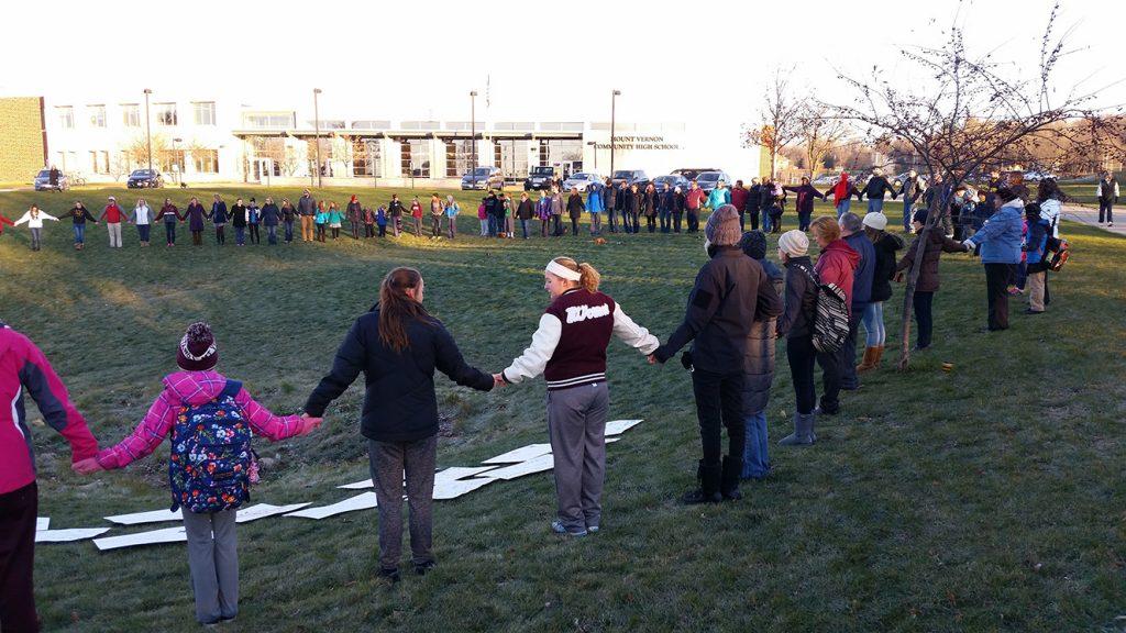 Community members gather peacefully before school Nov. 21 in a show of unity. Photo by Steve Brand.