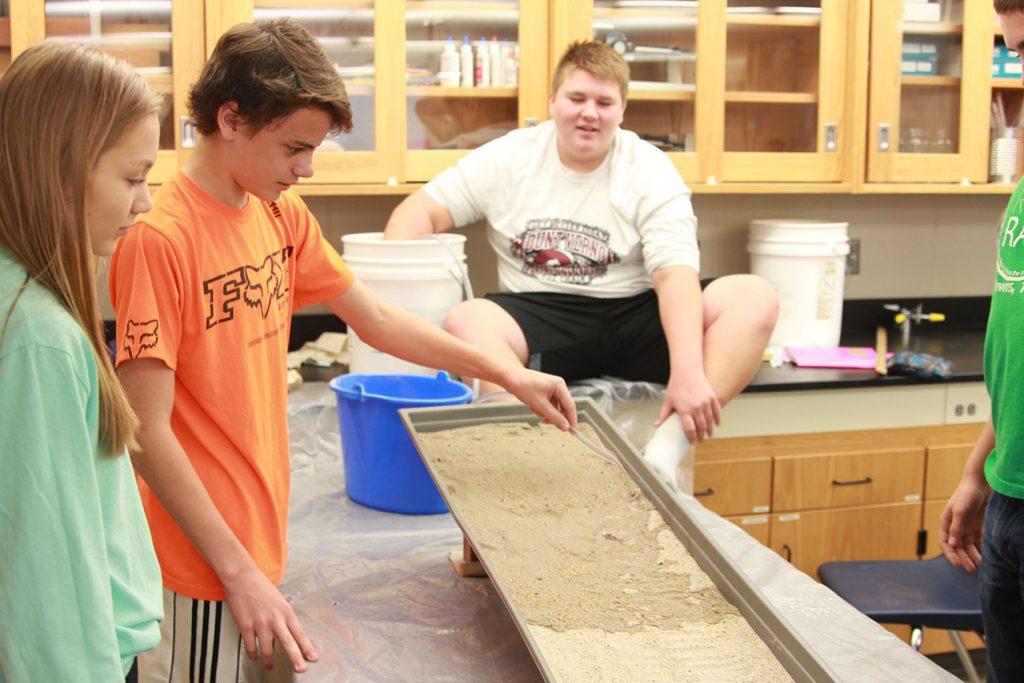 Freshmen Kyleigh Garcia, Wyatt Stanbro, and Mathew Trachta work on the stream lab Nov. 1. Photo by Brian Harris.