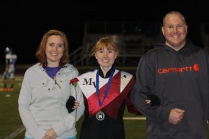 Mikayla Flockhart poses with her parents at senior night Oct. 14. Photo by Paige Zaruba.