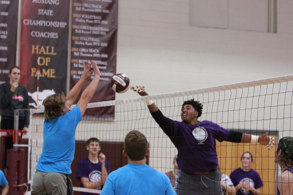 Senior Tristan Wirfs taps the ball over the net. Photo by Paige Zaruba. 