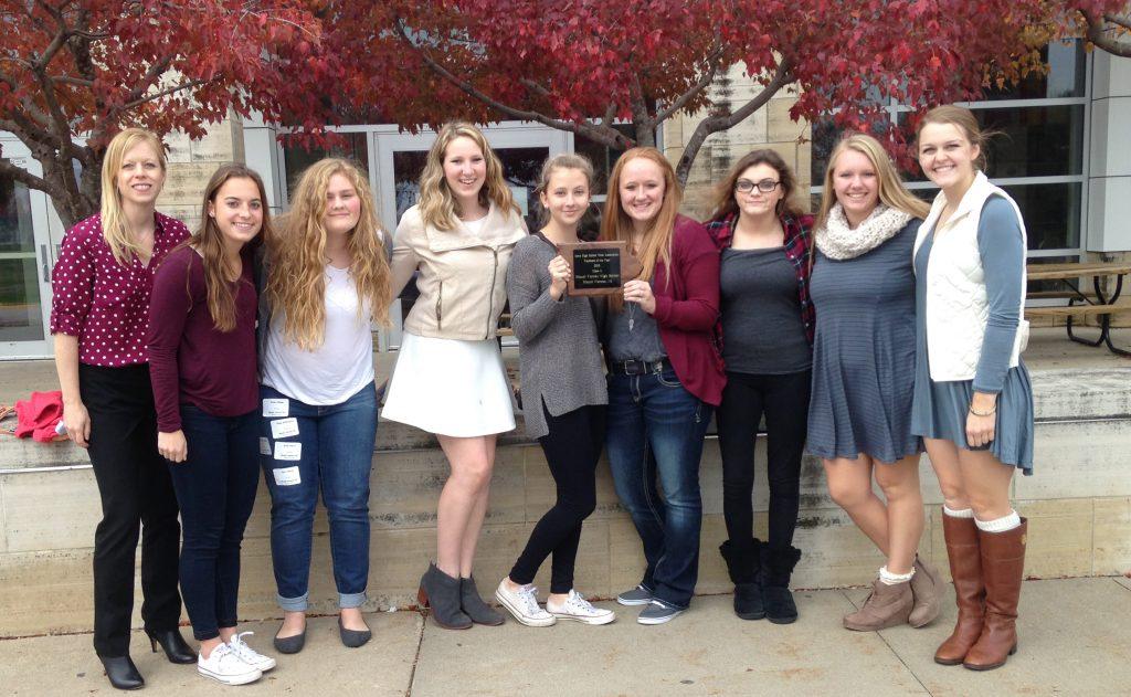Returning yearbook staffers claimed the trophy at the conference Oct. 27. Adviser JoAnn Gage, Sydney Hauser, Emma Klinkhammer, Rachel Bell, Bailey Priborsky, Alyssa Maddocks, Abby Davidson, Jessie Brokel, and Kelsey Shady.