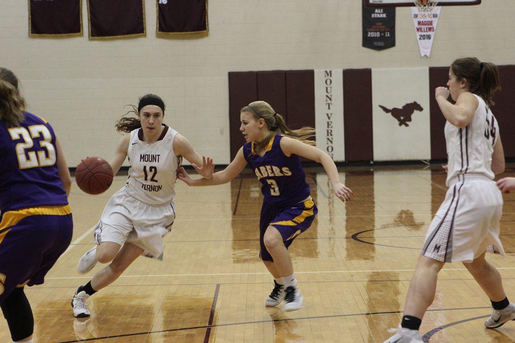Sophomore, Annie Rhomberg drives to the basket late in the third quarter. 